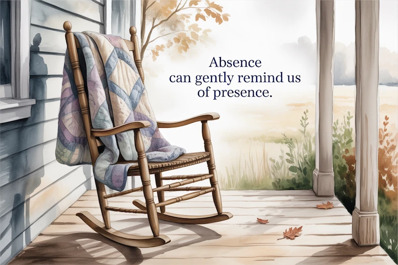 Watercolor empty chair on a porch, blanket draped over it.
Caption: “Absence can gently remind us of presence.”